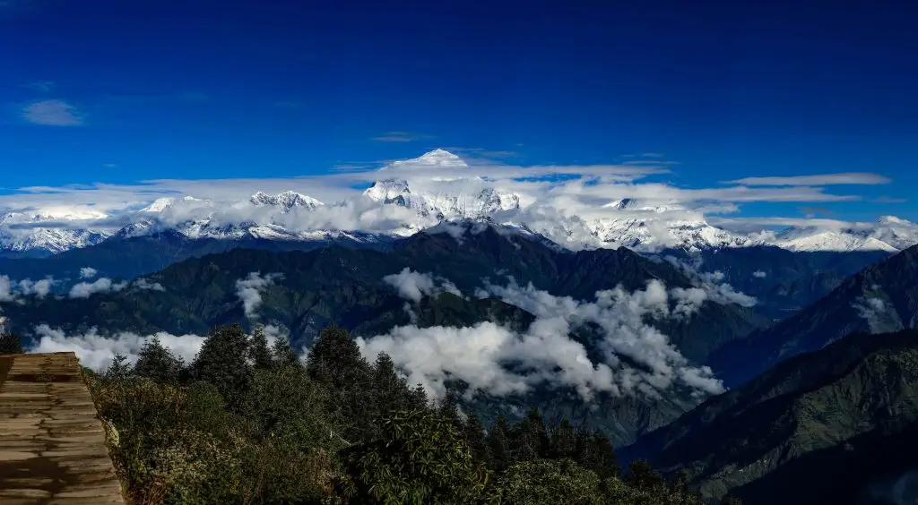 Majestic Himalayan view from Poon Hill with snow-capped peaks and lush greenery.