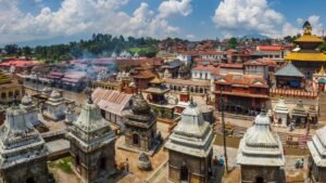 A panoramic view of Pashupatinath Temple in Kathmandu, Nepal, showcasing its ancient pagoda-style architecture, shrines, and cremation ghats along the Bagmati River.
