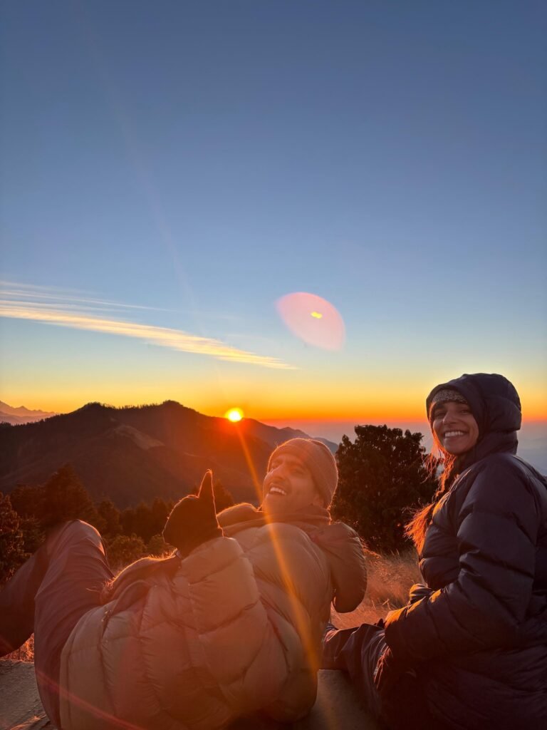 Trekkers enjoying sunrise at Ghorepani Poon Hill trek, with scenic mountain views.