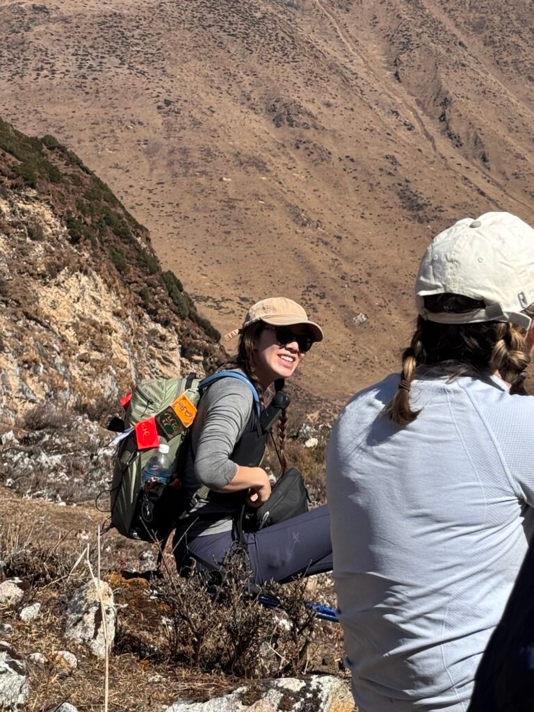 Trekkers resting on a mountain trail towards Pungin Gumba monastery in Nepal’s Manaslu Circuit