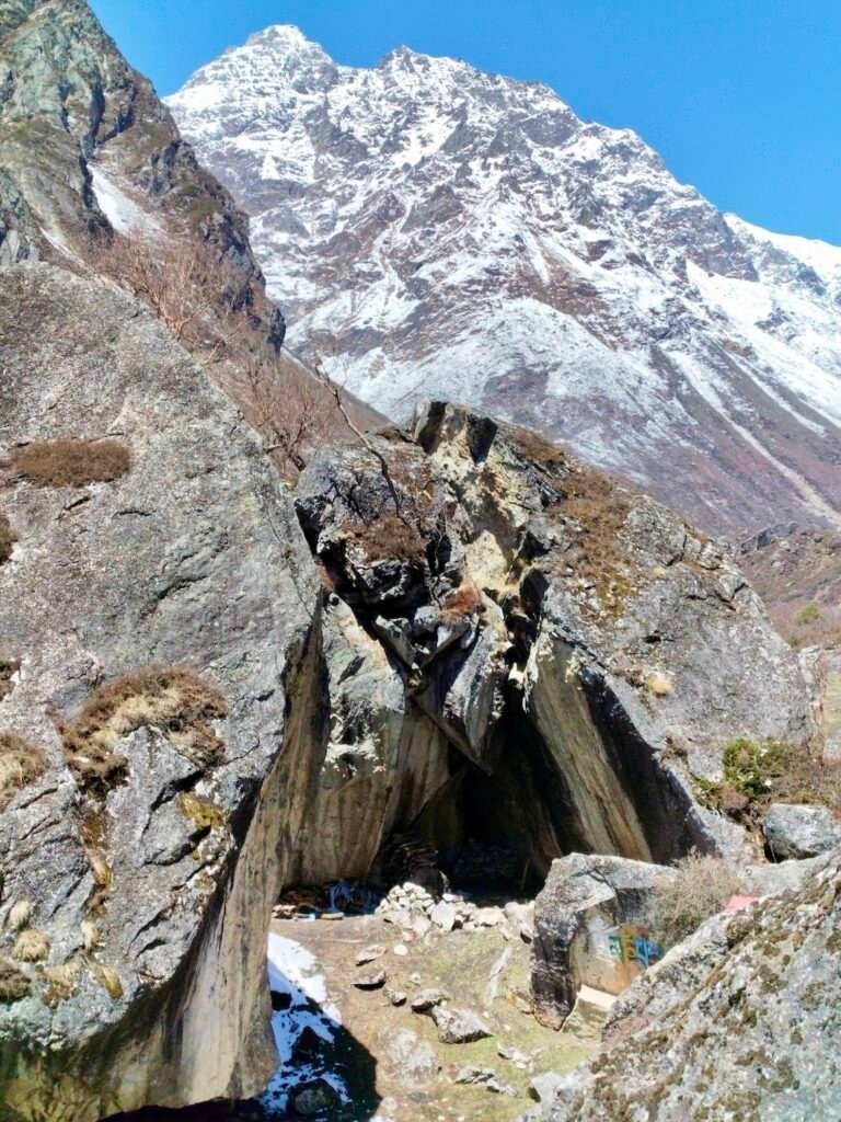 Panoramic view of rocky cliffs and snow-capped Himalayas from Lapchi Gumba viewpoint in Nepal